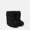 Botas de piel de oveja con lazo Gianni