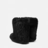 Botas de piel de oveja con lazo Gianni